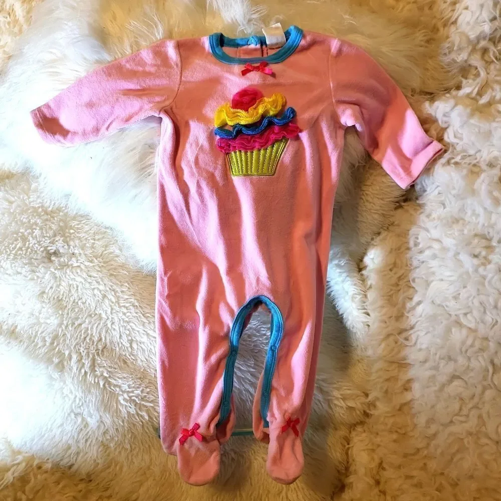 Brand new, pink one piece, velour so soft wit a cute cupcake and ruffled icing